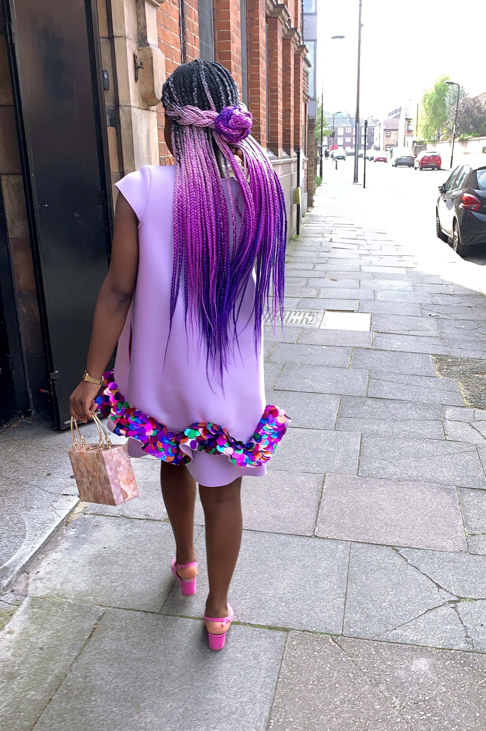 Black women with colourful hair wearing a lilac neoprene dress