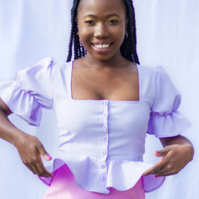 Tammy Silver wearing lilac blouse with puffy sleeves and peplum